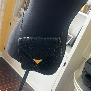 Elegant Black Crossbody Bag with Gold Detail